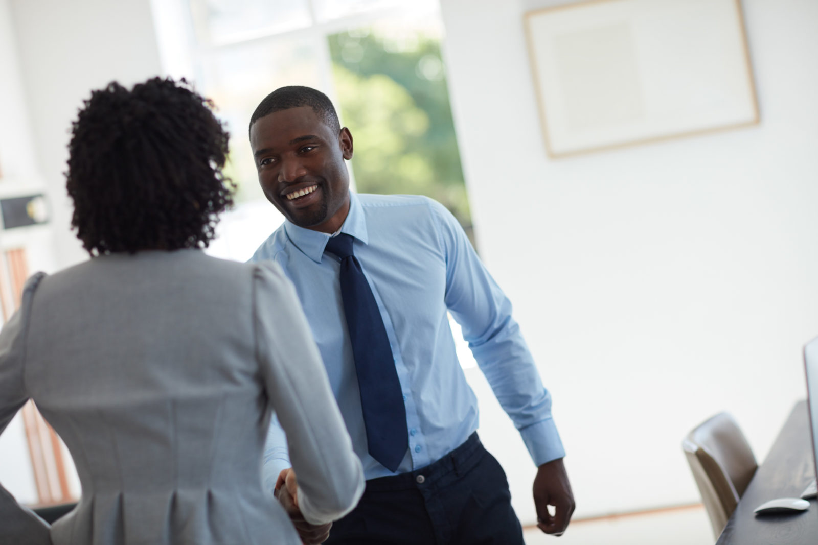 Cropped shot of  a businessman and businesswoman shaking hands in the office