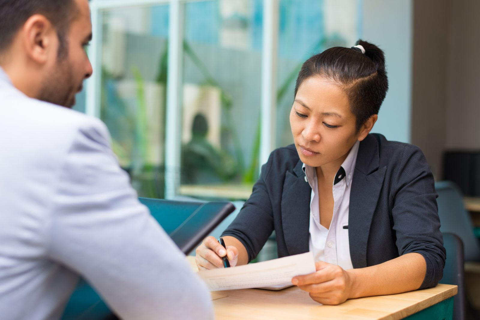 Asian executive manager meeting with job applicant in modern office