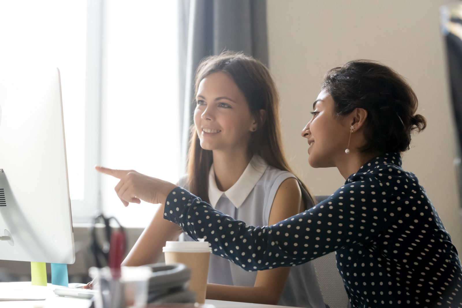 Two women working together at a desk